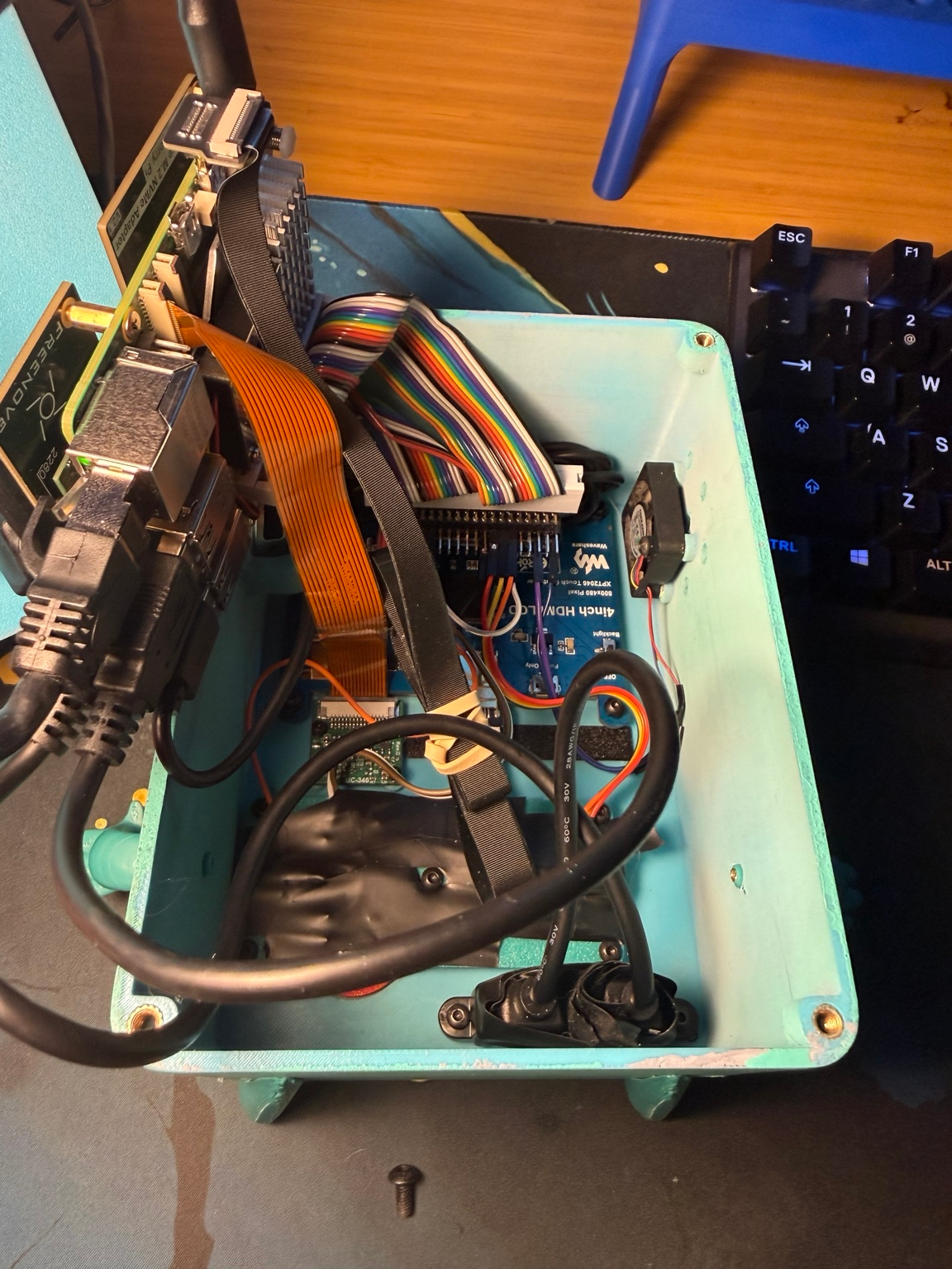 BMO enclosure interior showing the Raspberry Pi, display, wiring, and power components