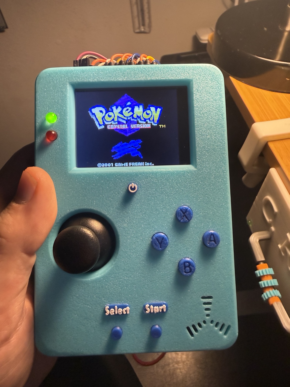 CHRISCADE handheld running Pokémon Crystal
