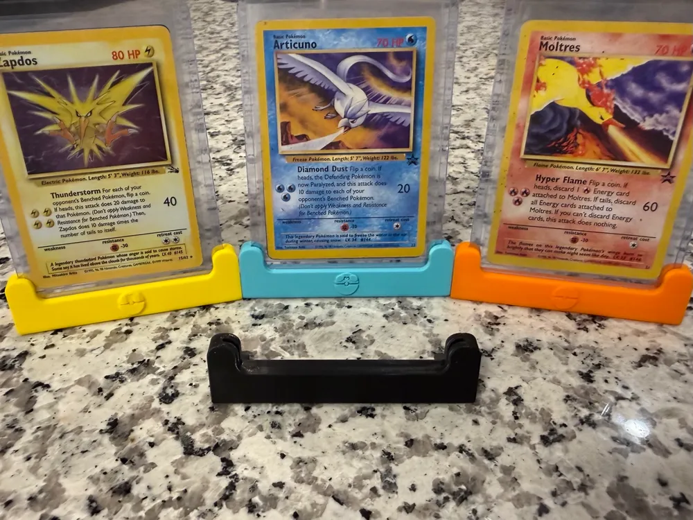 Colorful 3D-printed stands displaying Pokemon cards